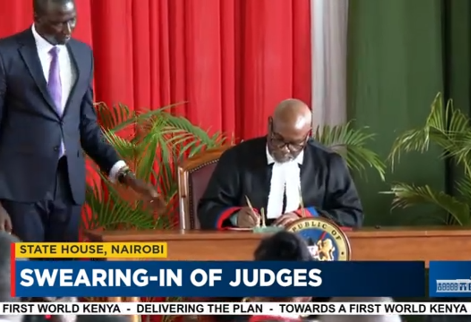 Hon. Justice Msungama signing in the oath book after being sworn in