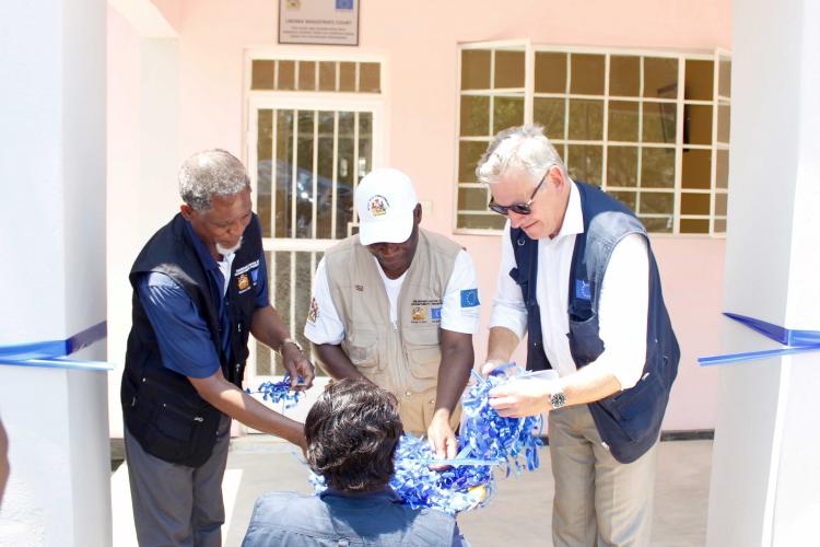 The Minister of Justice and Constitutional Affairs, the Chief Justice (middle) and the European Union Head of Delegation cutting the ribbon marking the official handover of Likoma District Magistrate Court.