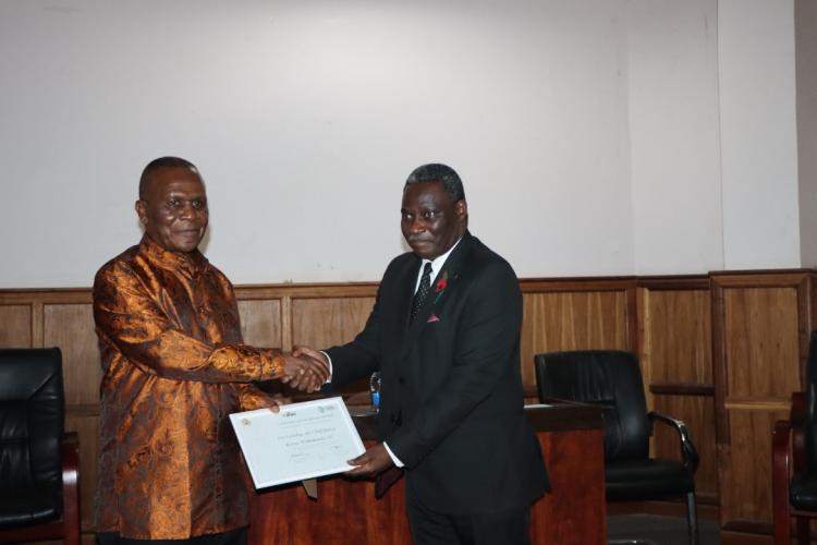 Prof.Richard Mkandawire Presenting the certificate to Chief Justice Mzikamanda, SC