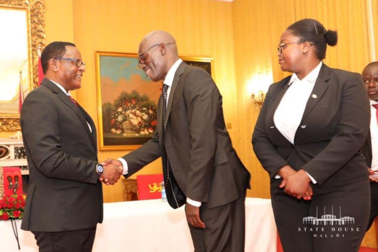 His Excellency the State President Congrats the newly sworn in Deputy Chief Justice after taking Oath of office. Looking on is the daughter of the Deputy Chief Justice