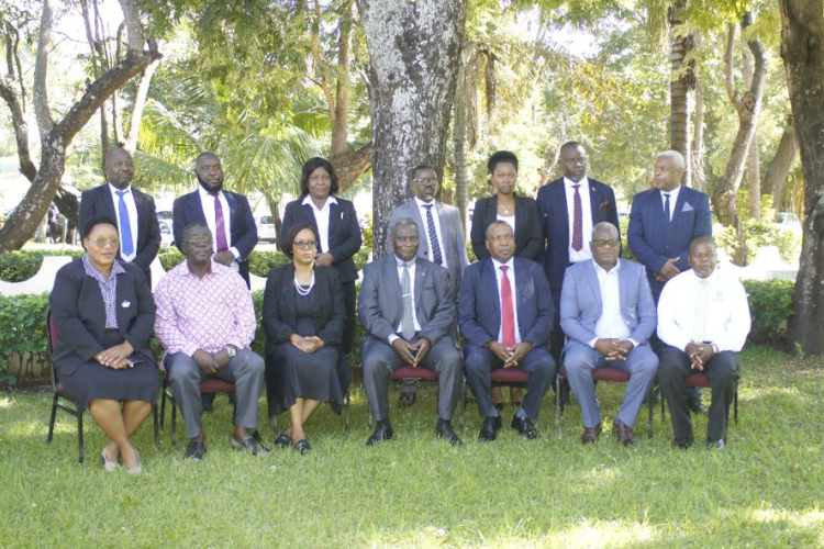 Deputy Directors and Assistant Chief Courts Administrators pose for a photograph with the Chief Justice (seated middle) and some facilitators at the Induction