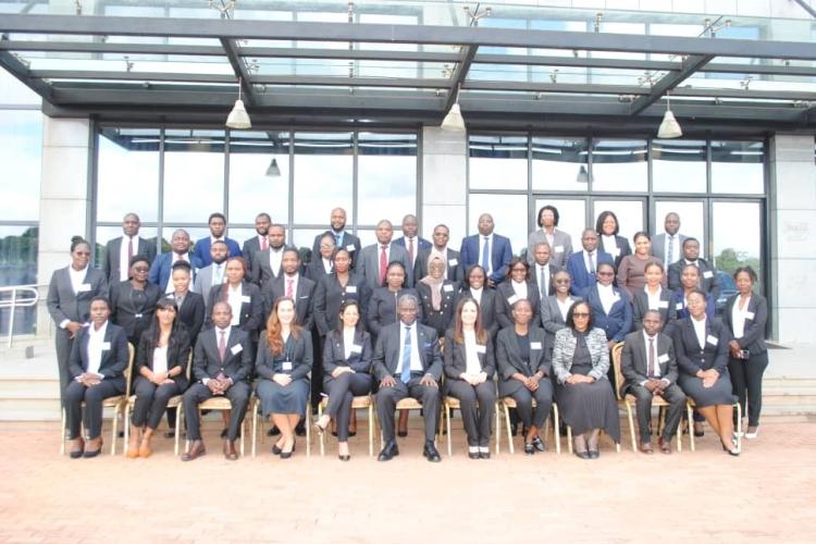 The Facilitators and the participants pose for a photograph with the Chief Justice (seated middle).